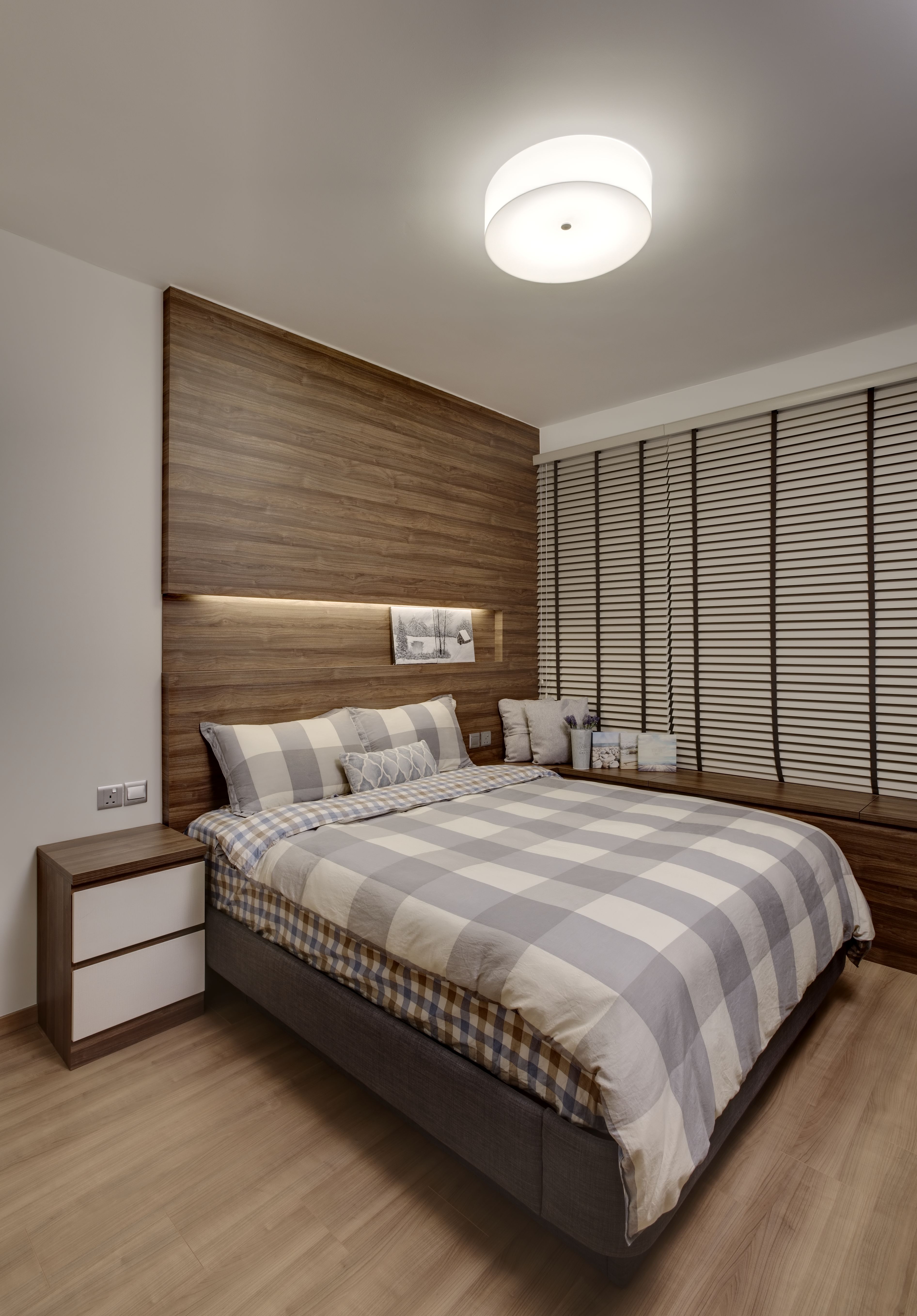The tatami blinds and grey checked bedsheets add a Japanese touch to the minimalist design