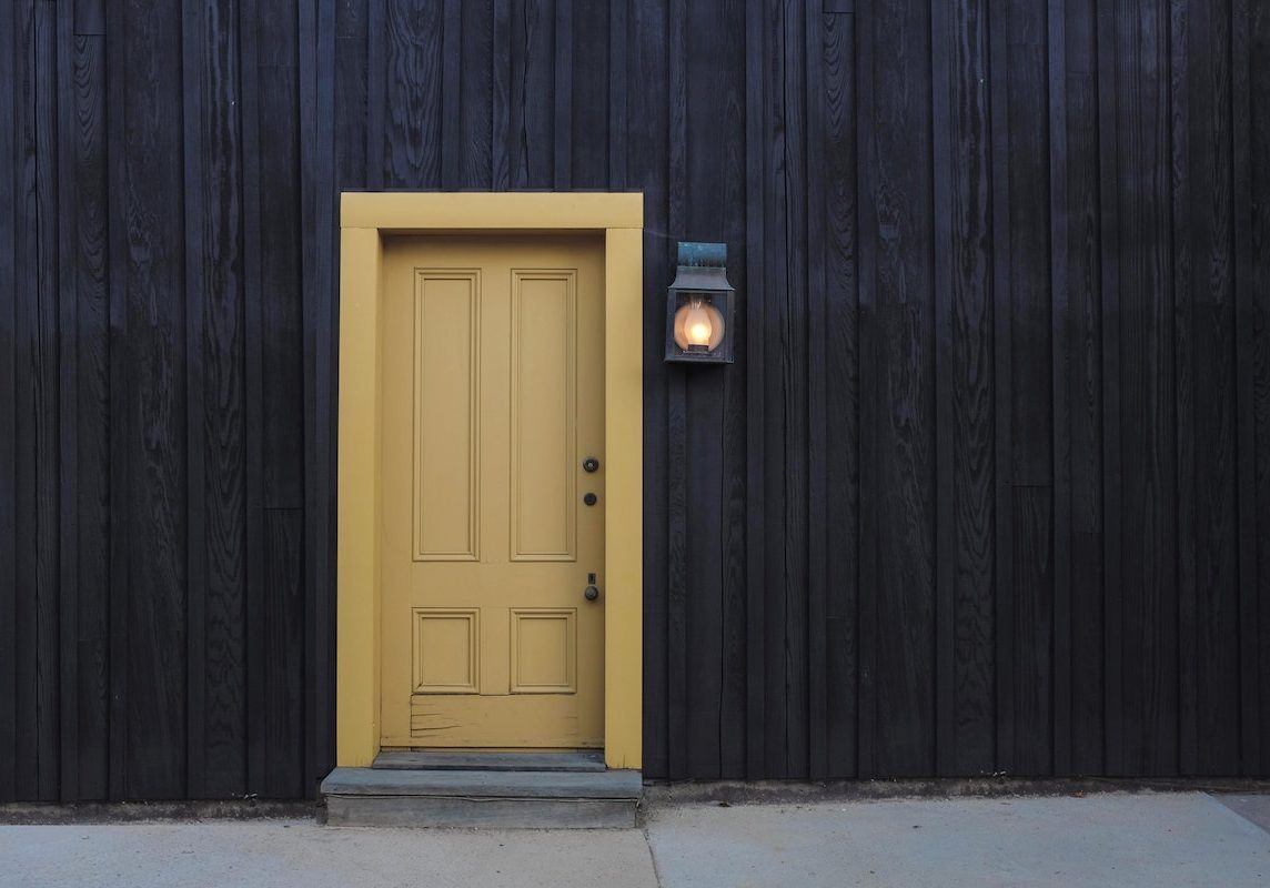 Yellow Door on Black Wall