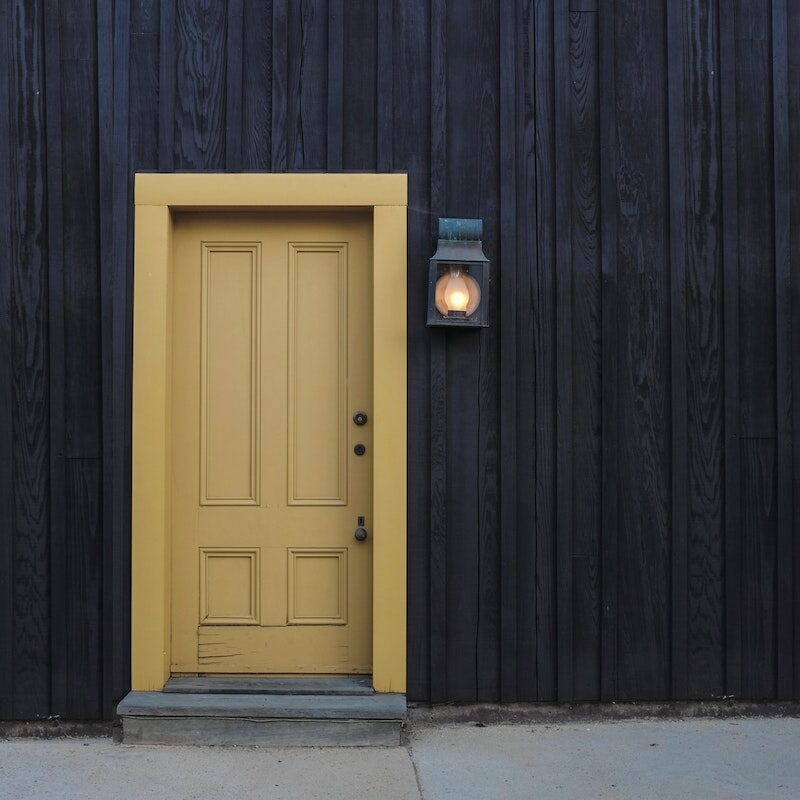 Yellow Door on Black Wall