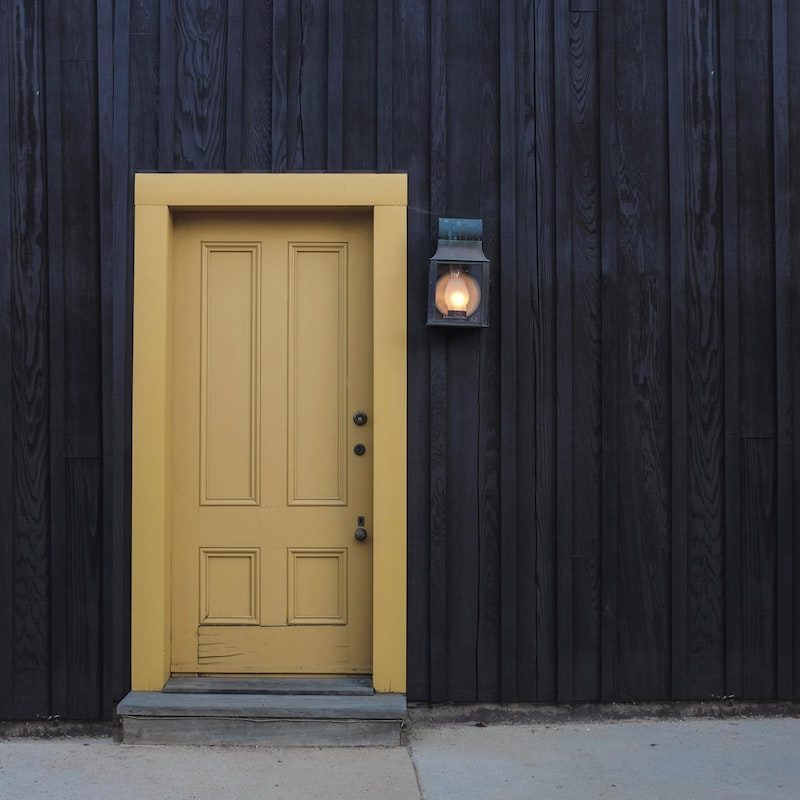 Yellow Door on Black Wall