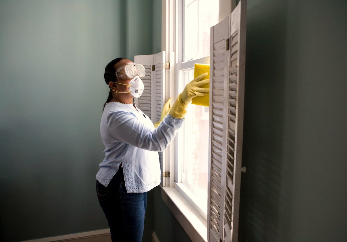 maid cleaning window